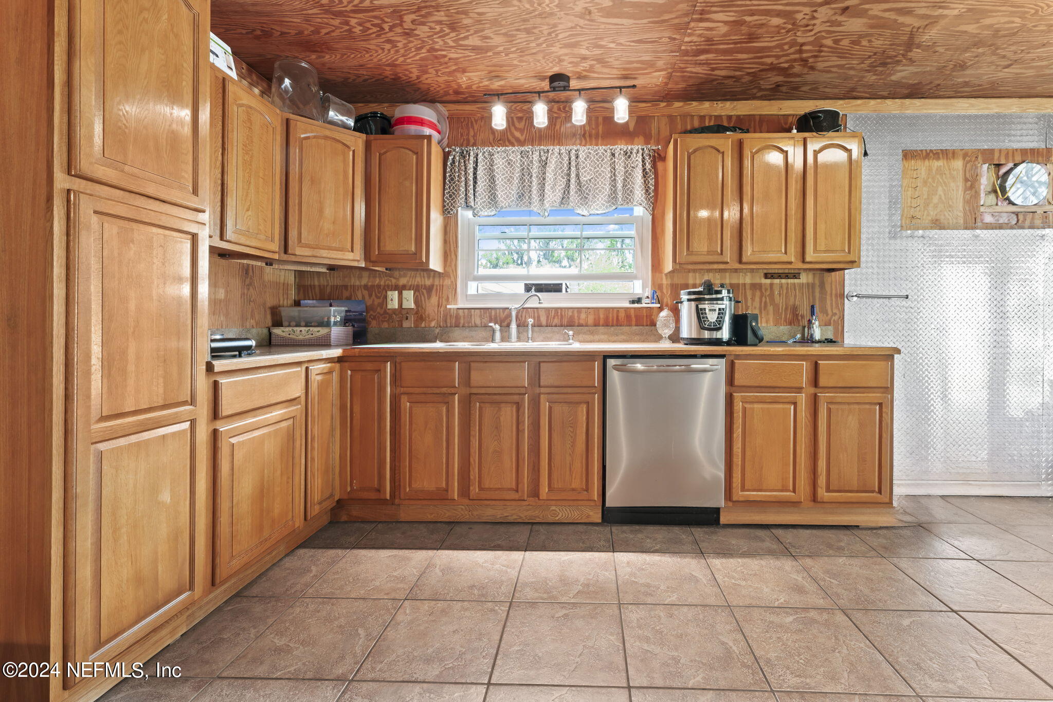 542284 Lem Turner Road Callahan, FL 32011 - Photo 49 of 84 a kitchen with stainless steel appliances granite countertop a refrigerator sink and cabinets