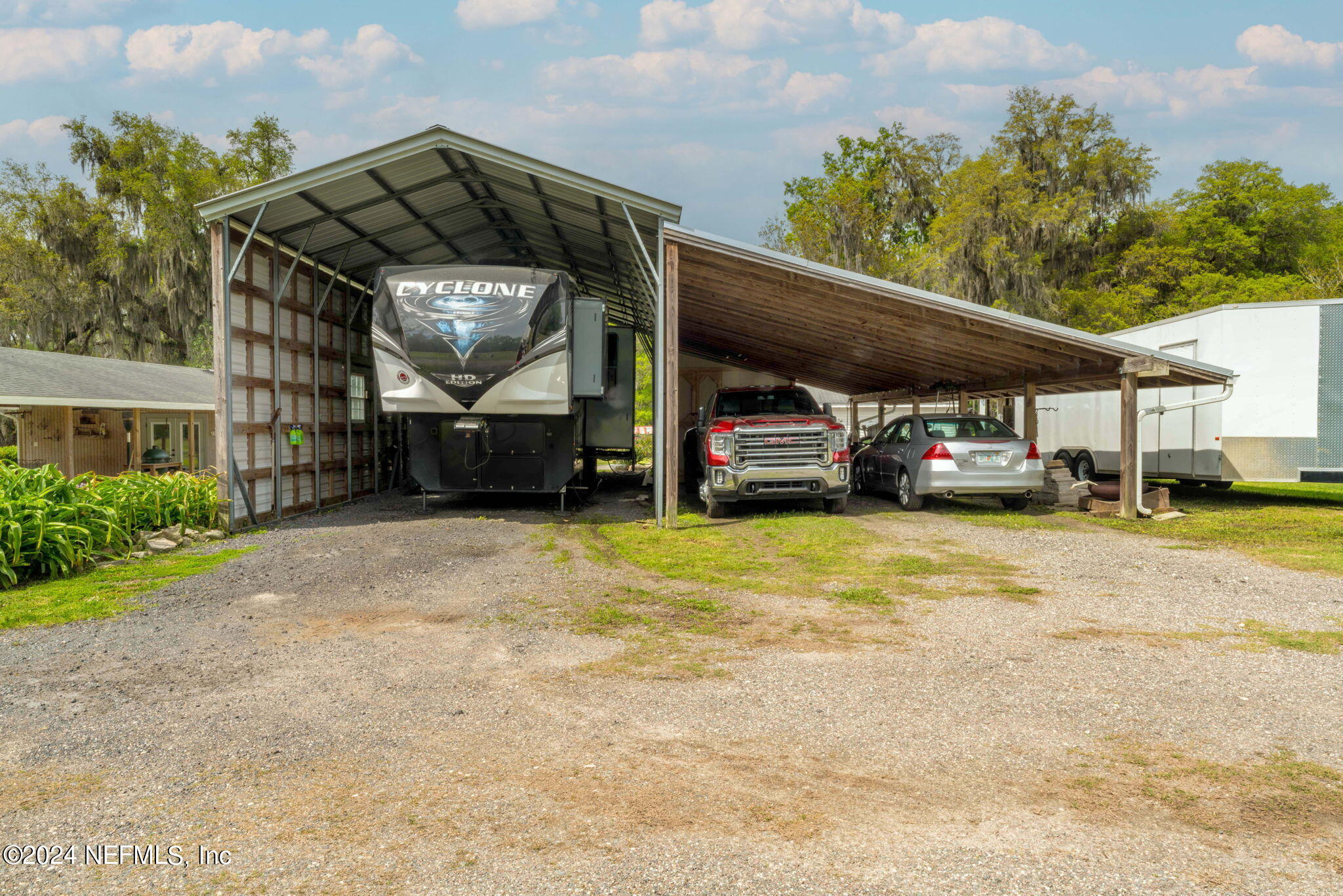 542284 Lem Turner Road Callahan, FL 32011 - Photo 56 of 84 a front view of a house with a garden and parking