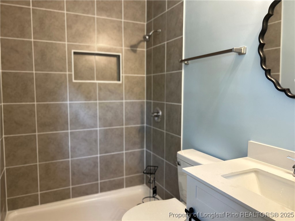 551 Alleghany Road Fayetteville, NC 28304 - Photo 12 of 13 a bathroom with a toilet and shower
