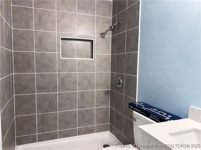 a bathroom with a toilet and a shower