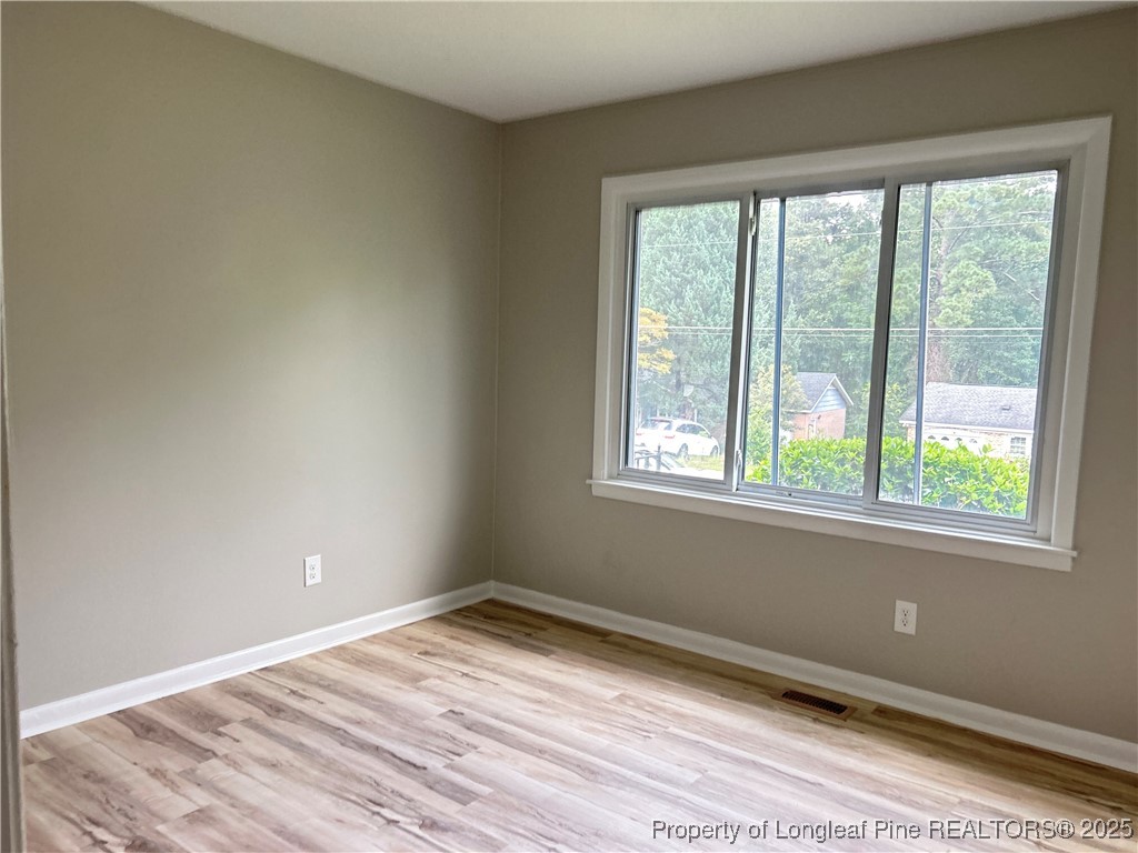 551 Alleghany Road Fayetteville, NC 28304 - Photo 7 of 13 a view of empty room with wooden floor and fan