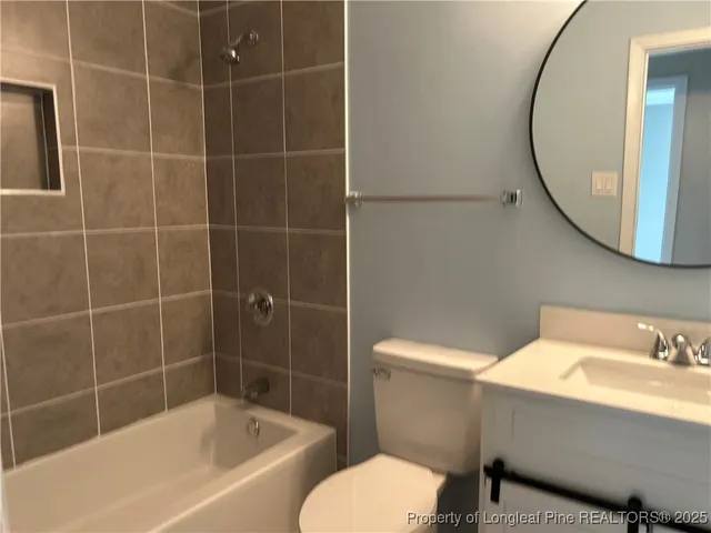 a bathroom with a sink a toilet and bathtub