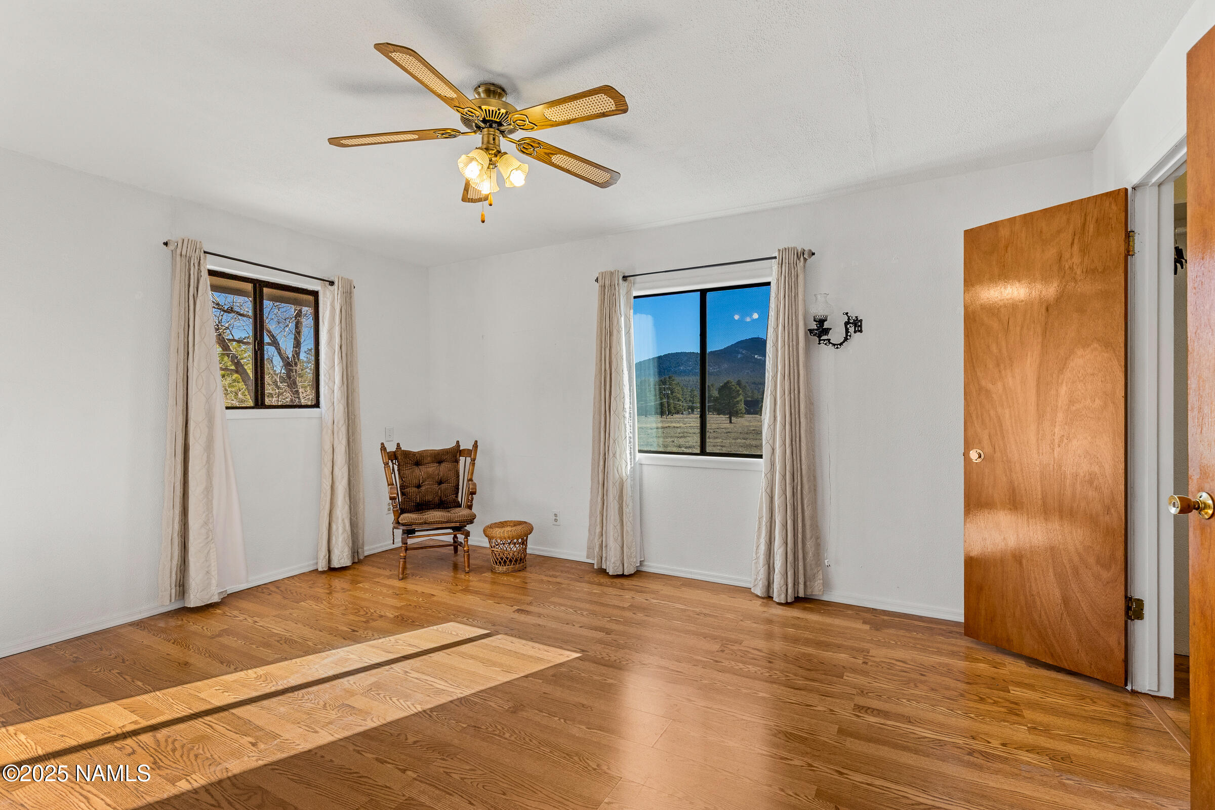 1843 Country Club Road Williams, AZ 86046 - Photo 18 of 36 a bedroom with a bed and a chair
