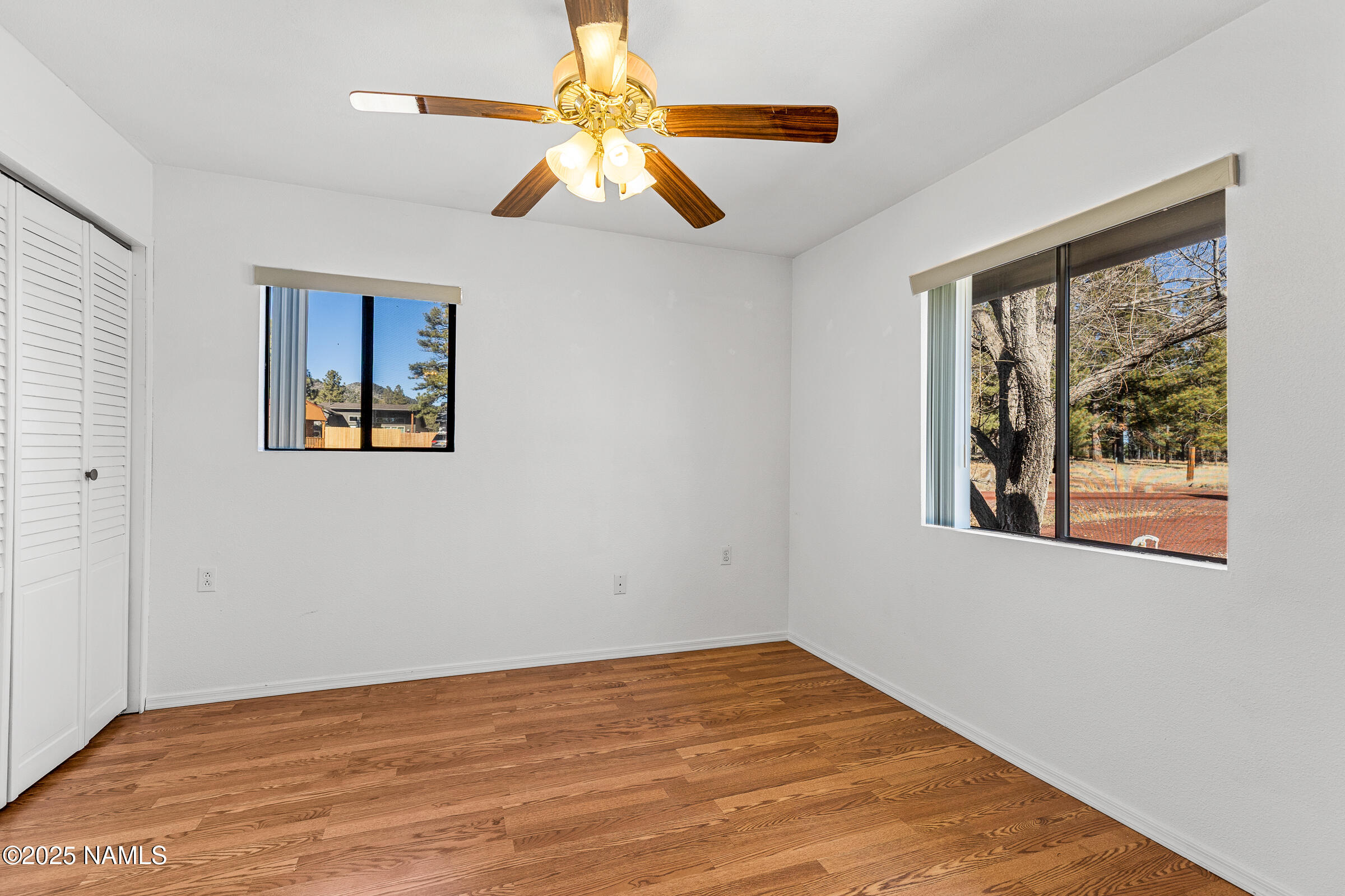 1843 Country Club Road Williams, AZ 86046 - Photo 23 of 36 a view of an empty room with window and wooden floor