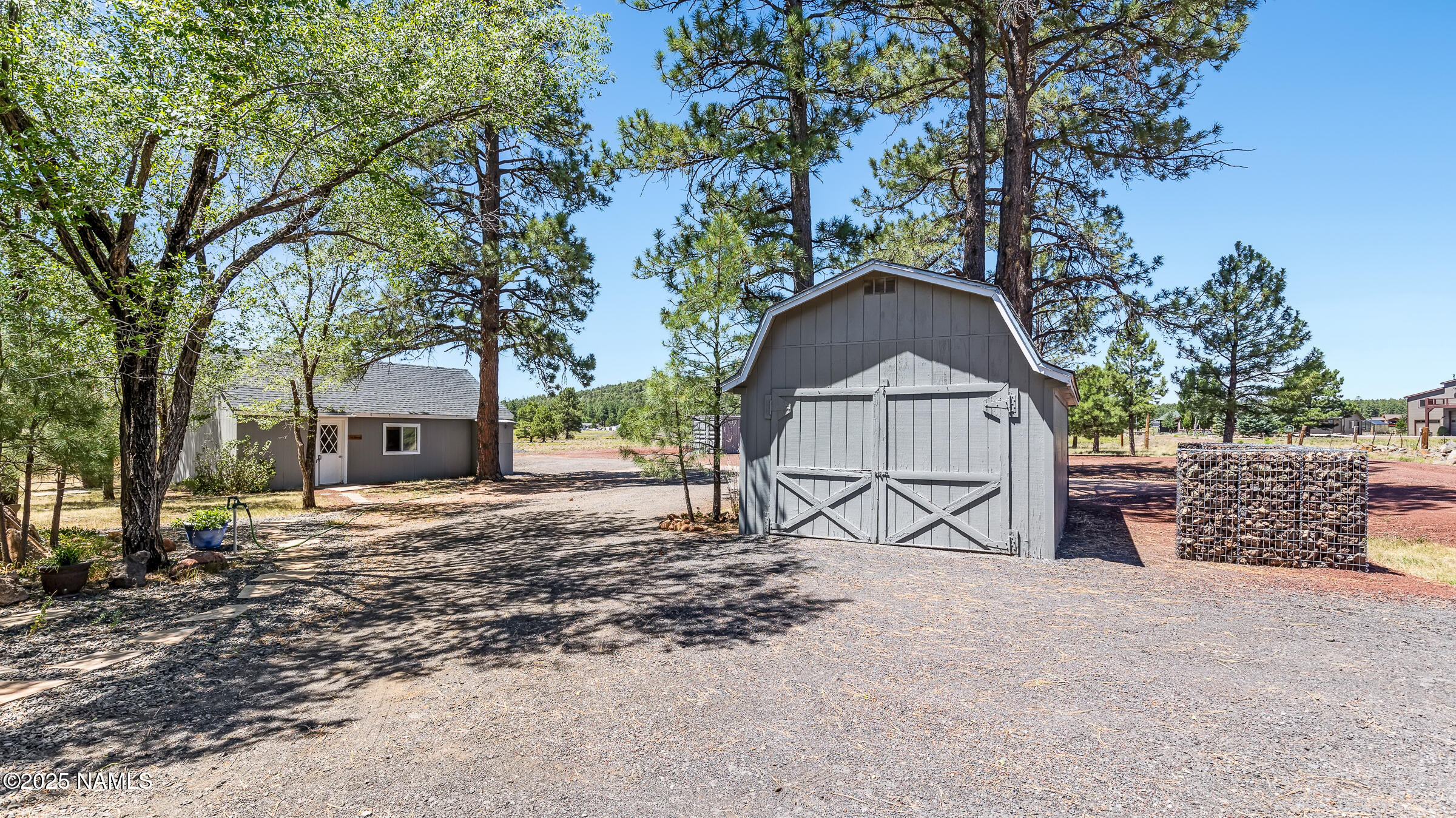 1843 Country Club Road Williams, AZ 86046 - Photo 28 of 36 a view of a house with large trees and wooden fence