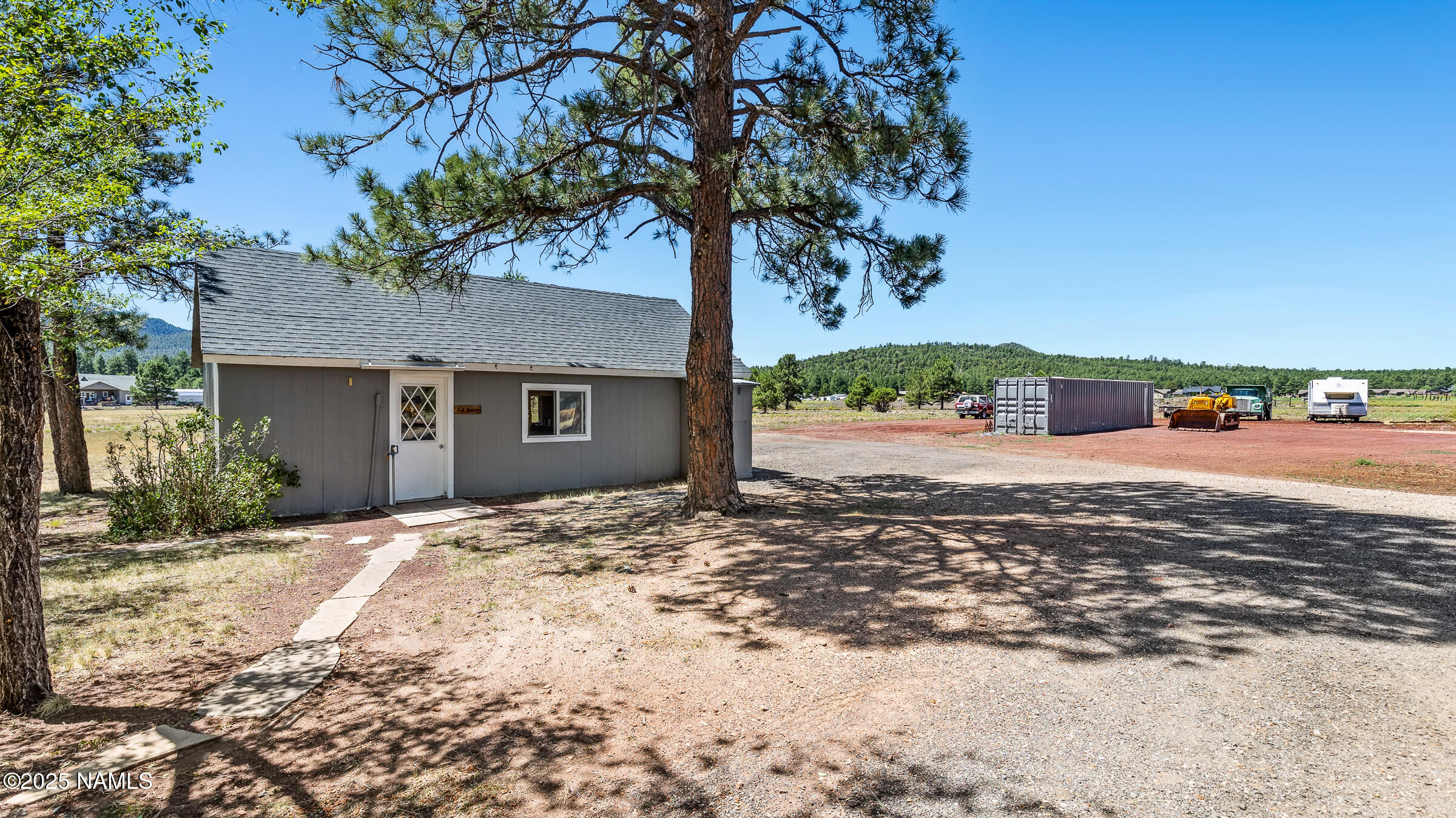 1843 Country Club Road Williams, AZ 86046 - Photo 30 of 36 a front view of a house with a yard and garage