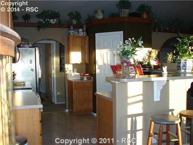 8236 Tipperary Road Peyton, CO 80831 - Photo 16 of 16 Nice open floor plan with kitchen counter and pantry.
