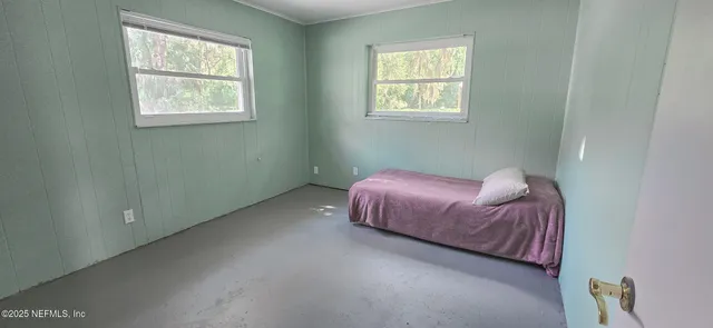 a spacious bedroom with a bed and window