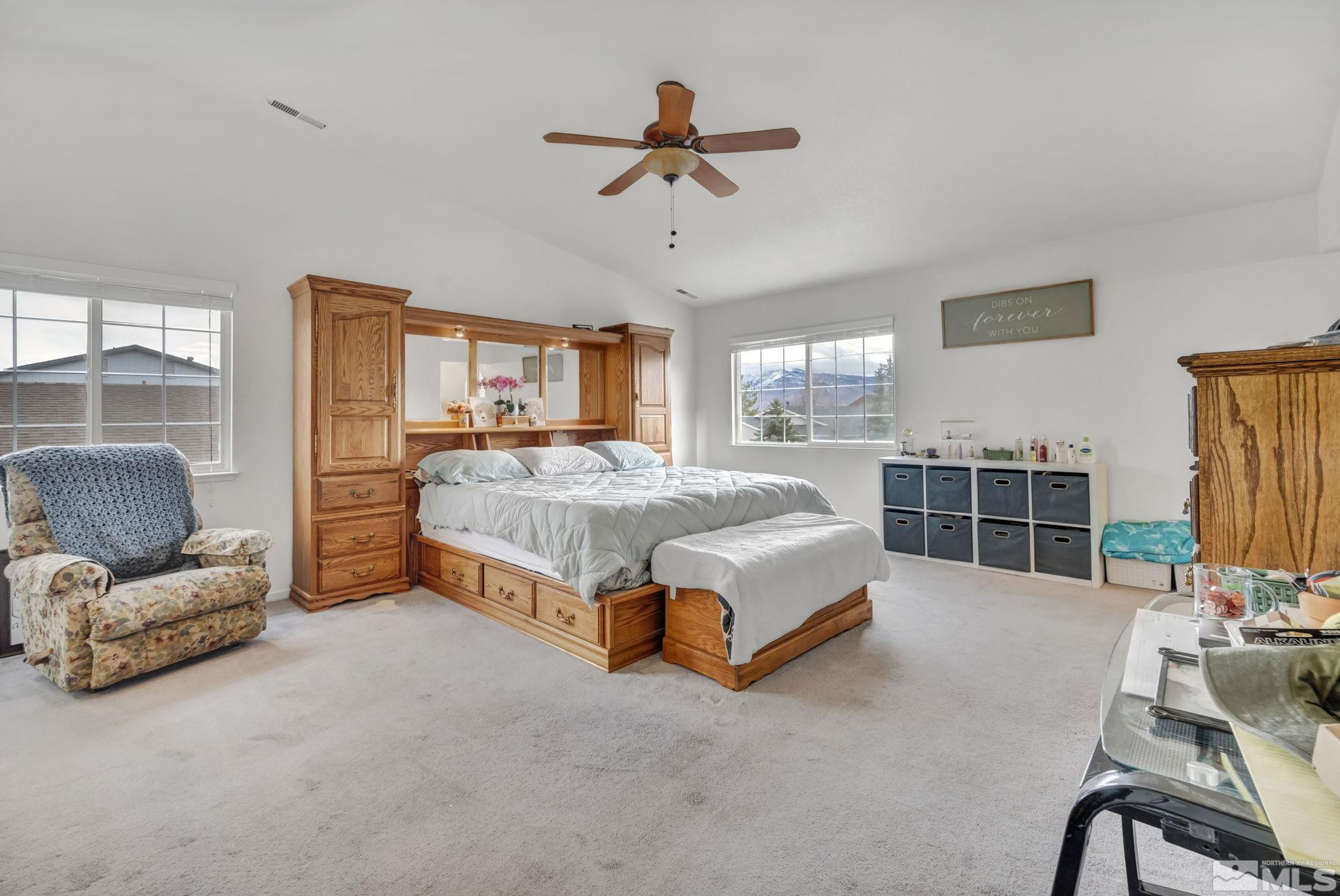 17795 Oakview Court Reno, NV 89508 - Photo 14 of 34 a spacious bedroom with a bed a couch and a chandelier