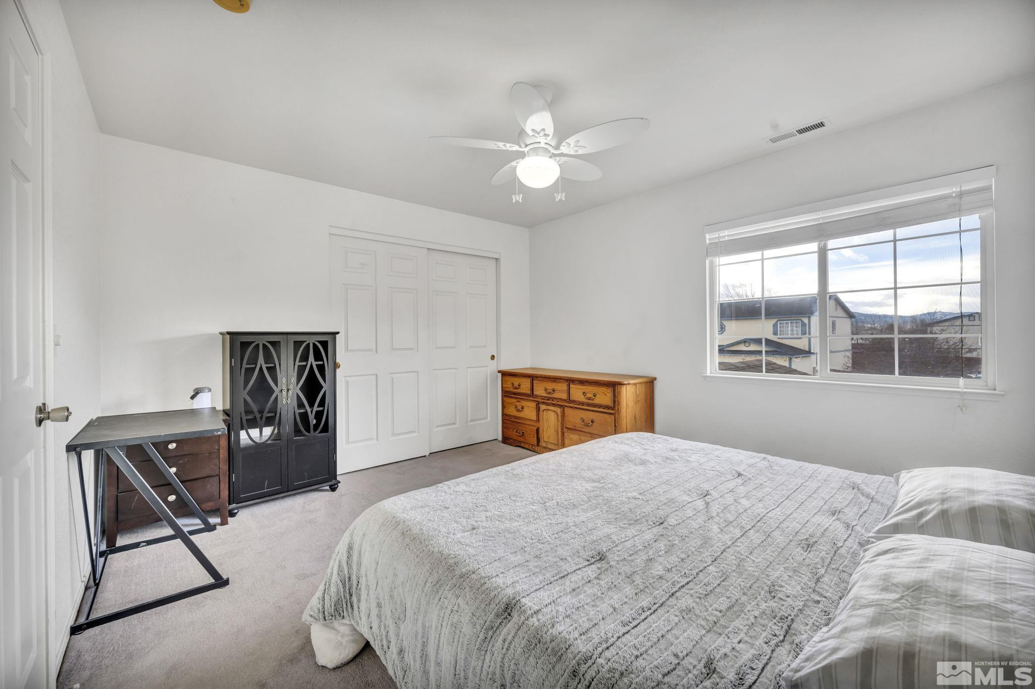 17795 Oakview Court Reno, NV 89508 - Photo 19 of 34 a bedroom with a bed and a chair