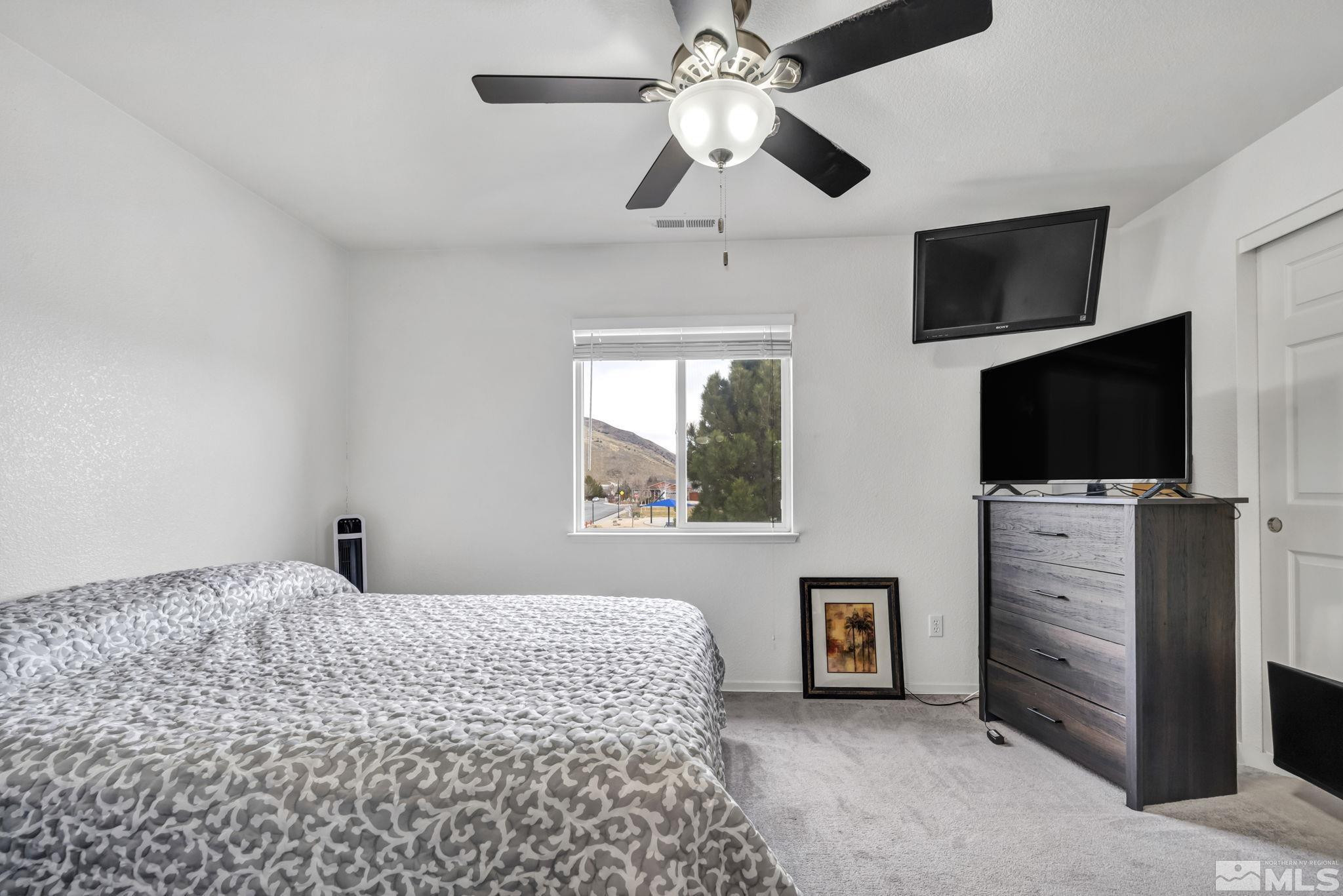 17795 Oakview Court Reno, NV 89508 - Photo 20 of 34 a bedroom with a bed and a flat screen tv