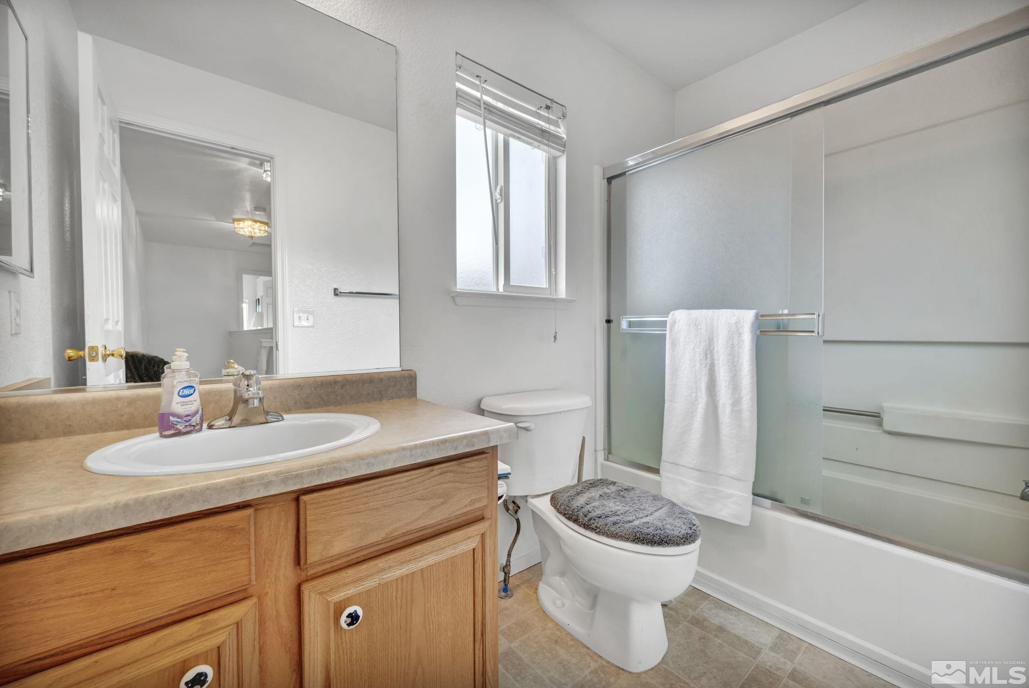 17795 Oakview Court Reno, NV 89508 - Photo 22 of 34 a bathroom with a granite countertop toilet sink and mirror