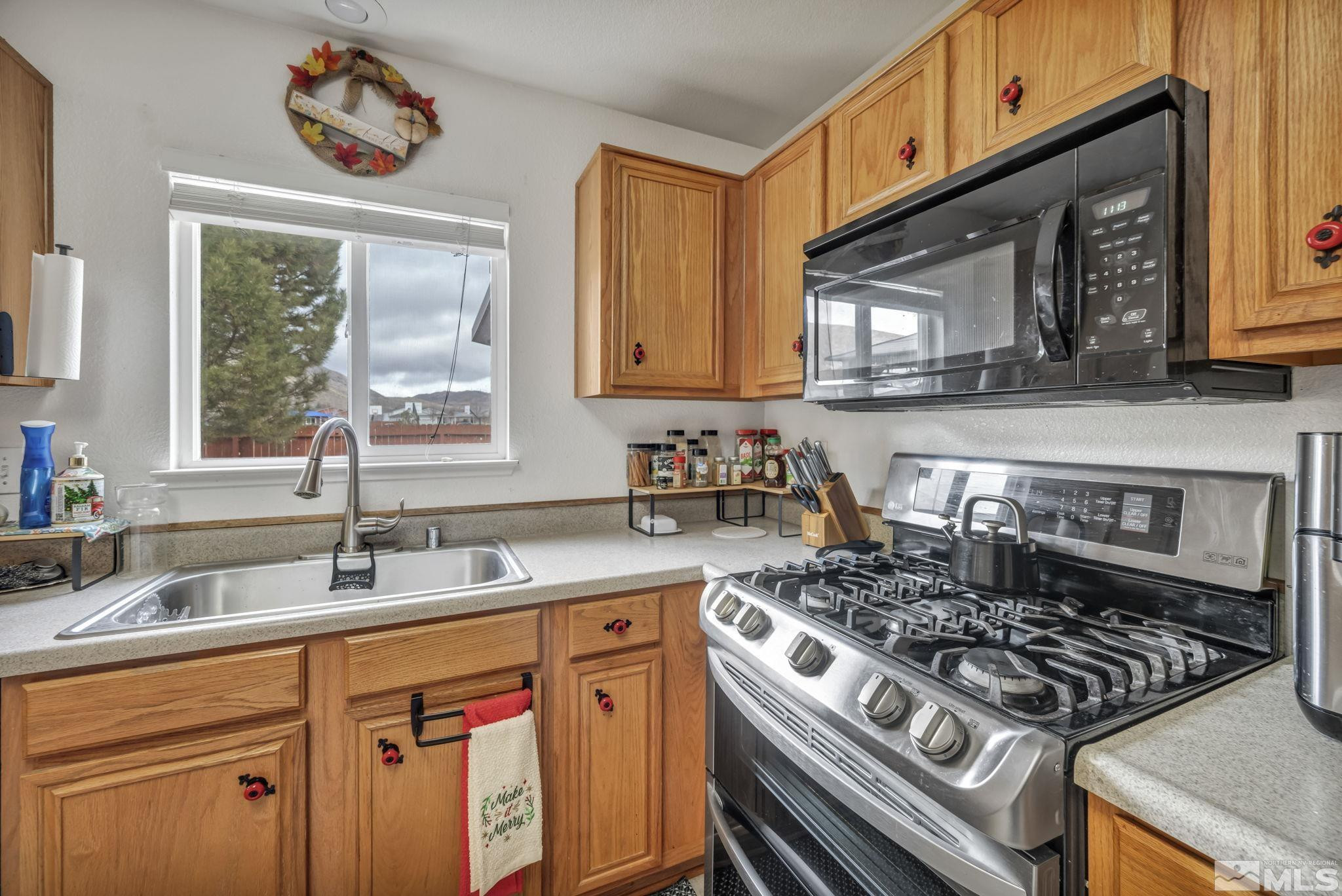 17795 Oakview Court Reno, NV 89508 - Photo 8 of 34 a kitchen with a stove a sink and a microwave