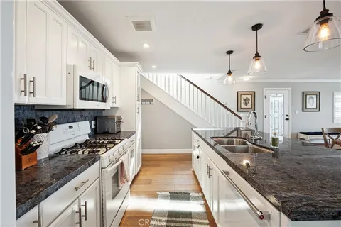 a kitchen with sink cabinets and wooden floor
