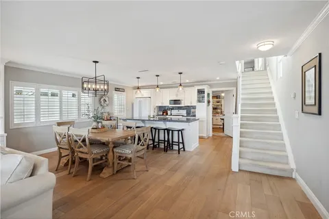 a living room with furniture a flat screen tv and a floor to ceiling window