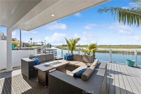 a bedroom with a large bed a large window and a chandelier