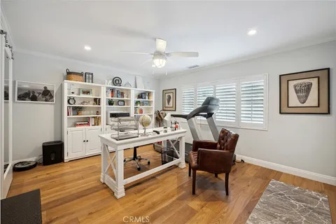a living room with furniture and painting on the wall