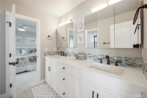 an aerial view of ocean and residential houses with outdoor space