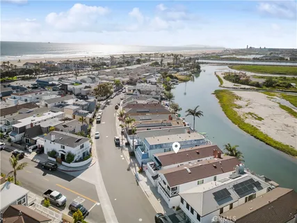 an aerial view of residential houses with outdoor space and swimming pool