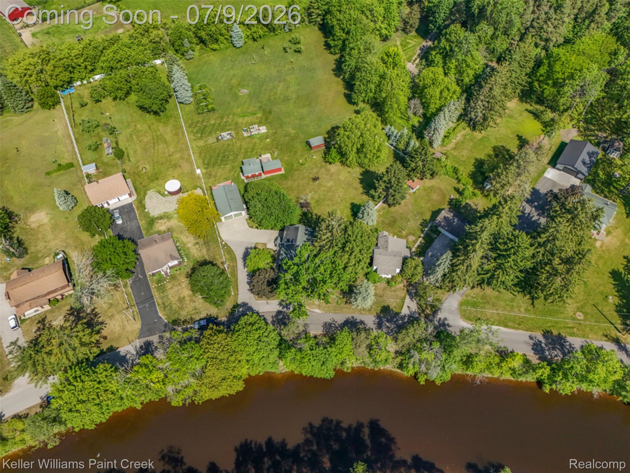 204 Russell Road Kawkawlin, MI 48631 - Photo 59 of 82 Expansive property featuring a riverfront setting, mature trees, multiple outbuildings, paved driveways, and surrounding green space