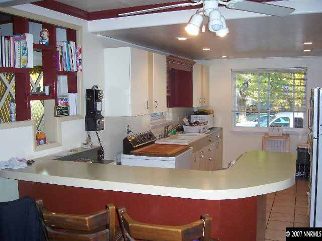 1685 Jackson Place Reno, NV 89512 - Photo 3 of 9 a room with wooden floor table and a large window