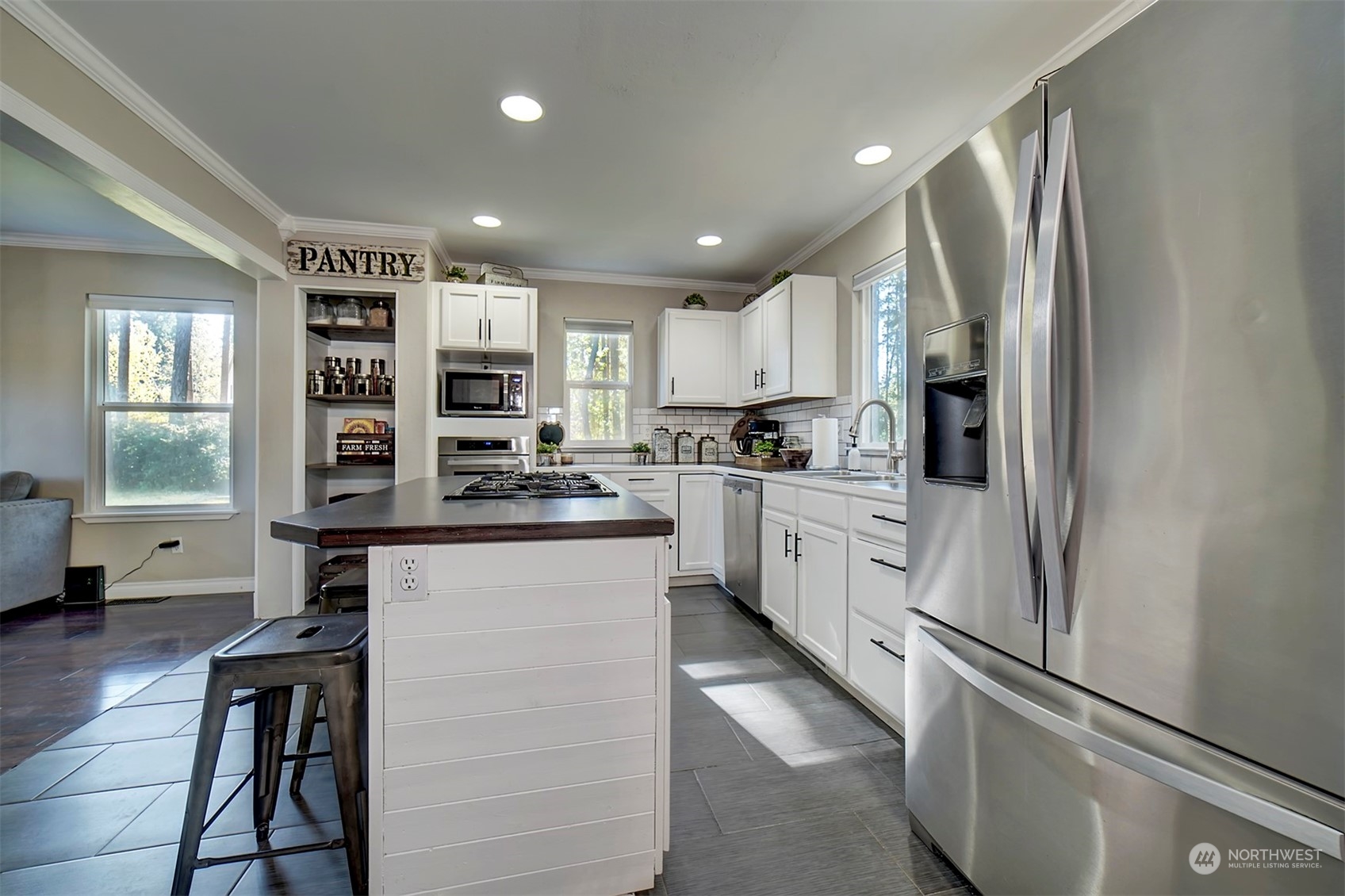 2016 Southeast Cedar Road Port Orchard, WA 98367 - Photo 8 of 30 a kitchen with stainless steel appliances a refrigerator sink and cabinets