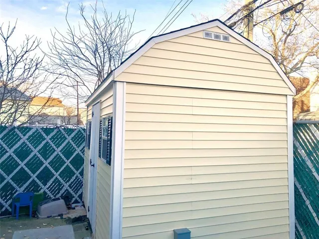 a roof deck with wooden floor and city view