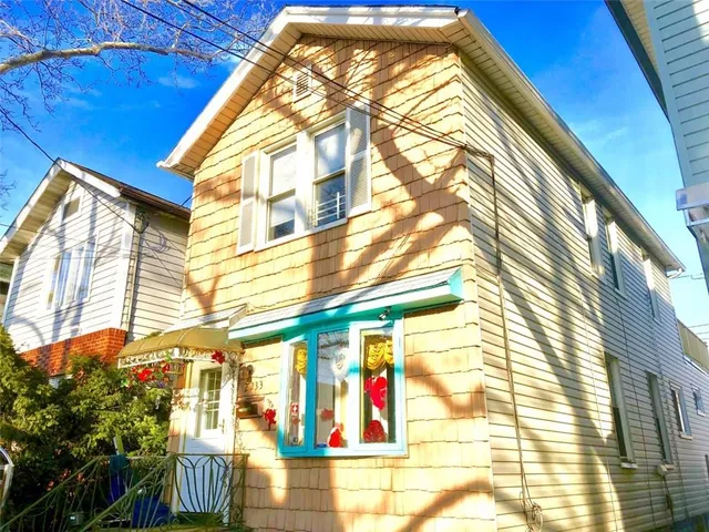 a view of a white car parked in front of a house