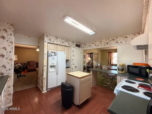 a kitchen that has a sink a stove and a refrigerator