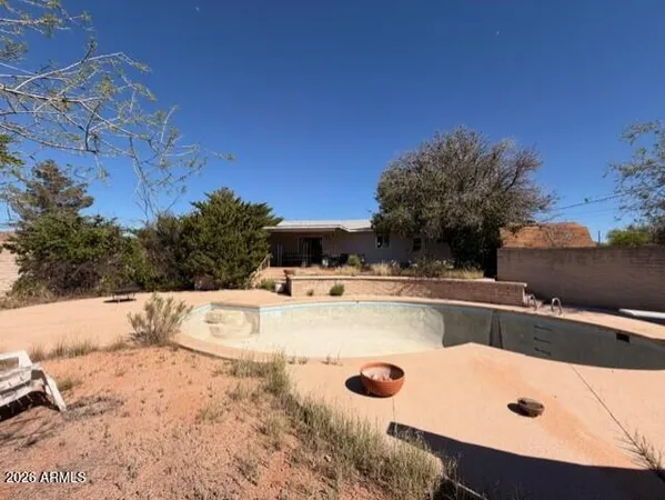a view of a swimming pool with a yard