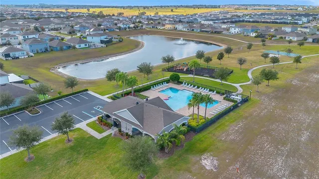 an aerial view of residential houses with outdoor space and swimming pool