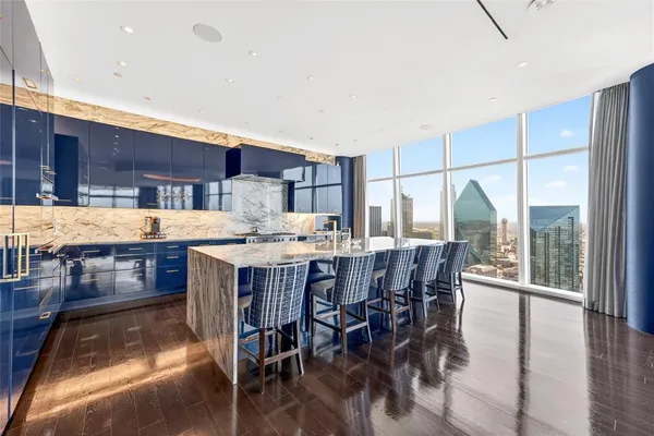 a dining hall with stainless steel appliances a table and chairs