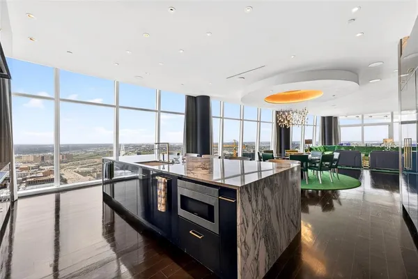 a kitchen with a large window and cabinets