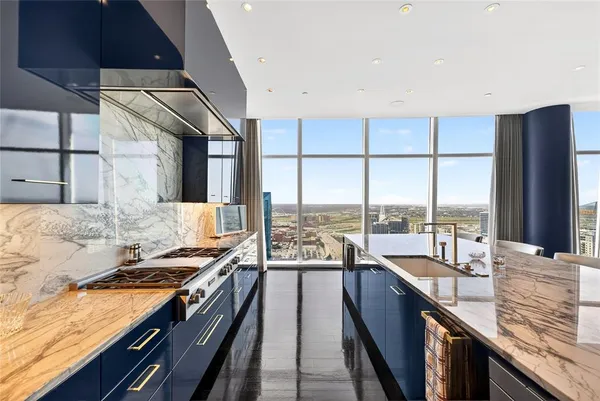 a kitchen with stainless steel appliances granite countertop a stove and a sink
