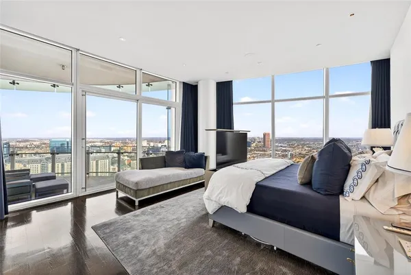 a bedroom with a large bed and a large window