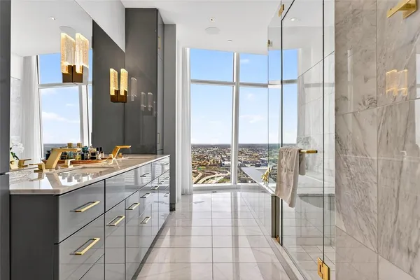 a spacious bathroom with a double vanity sink a mirror and a shower