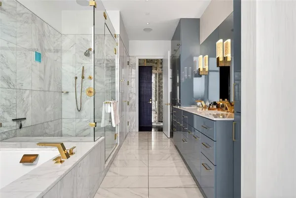 a bathroom with a tub sink and mirror