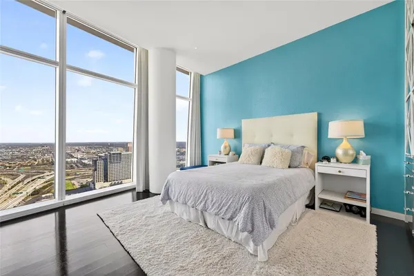 a bedroom with a large bed and a large window