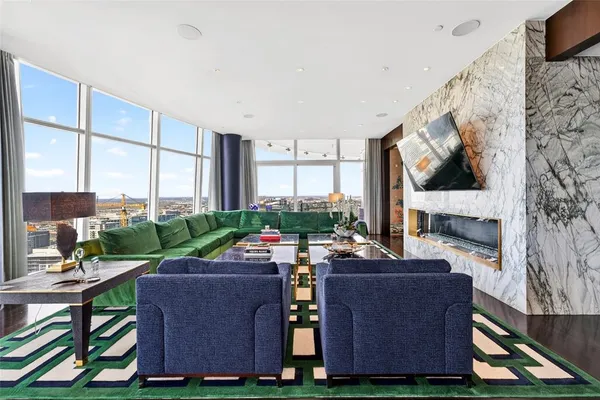 a living room with furniture a fireplace and a flat screen tv