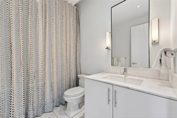 a bathroom with a sink toilet and shower