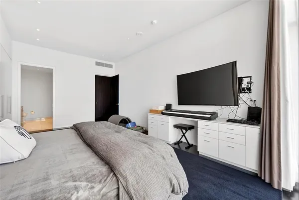 a bedroom with a flat screen tv and a bed