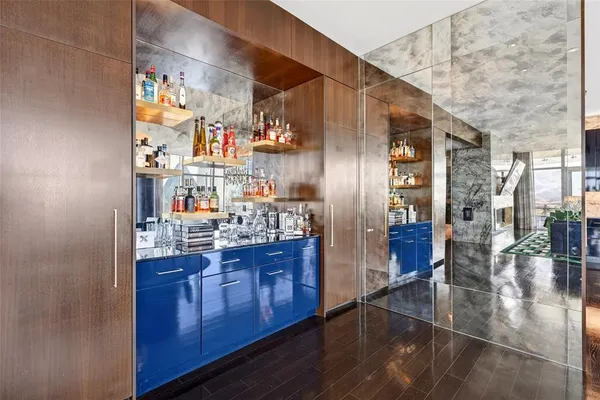 a kitchen with granite countertop a refrigerator and wooden floor