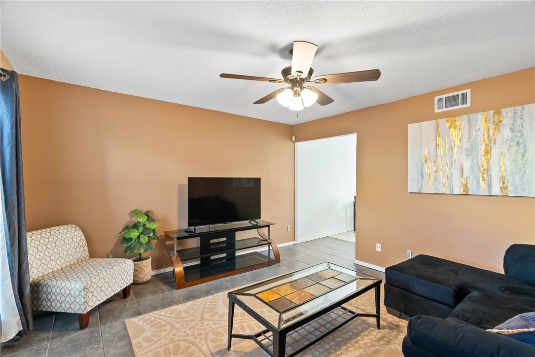 6702 Everhart Road, Unit H102 Corpus Christi, TX 78413 - Photo 2 of 15 a living room with furniture and a flat screen tv