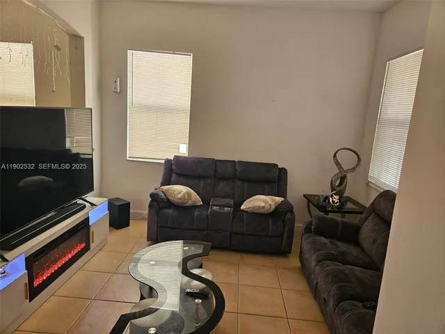 a livingroom with workspace and a couch