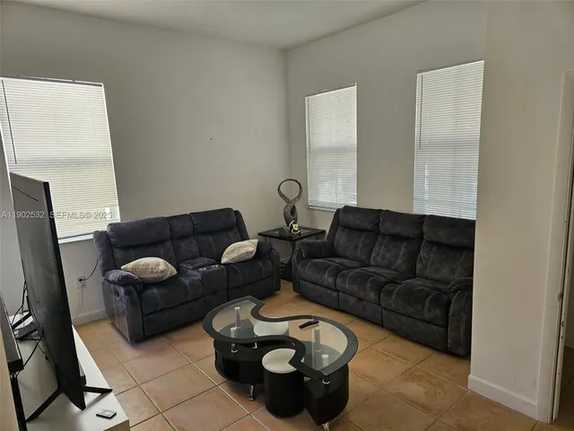 a kitchen with granite countertop a refrigerator stove and microwave