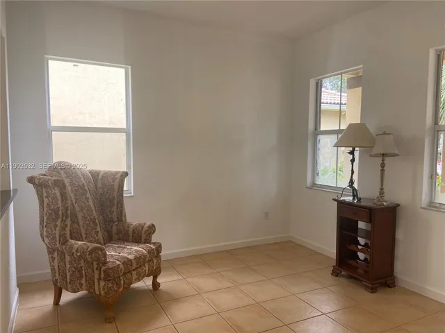 a living room with a book shelf and a book shelf
