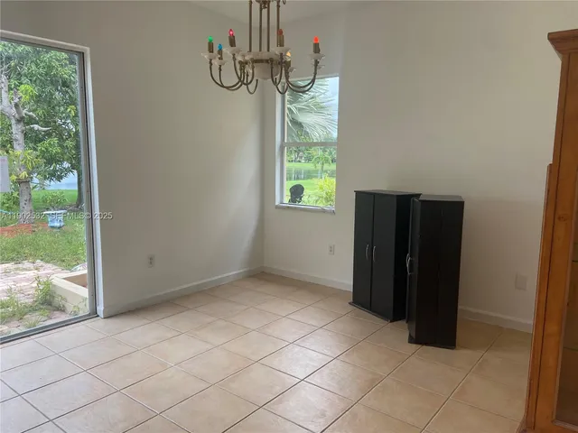 a room with pool table and windows