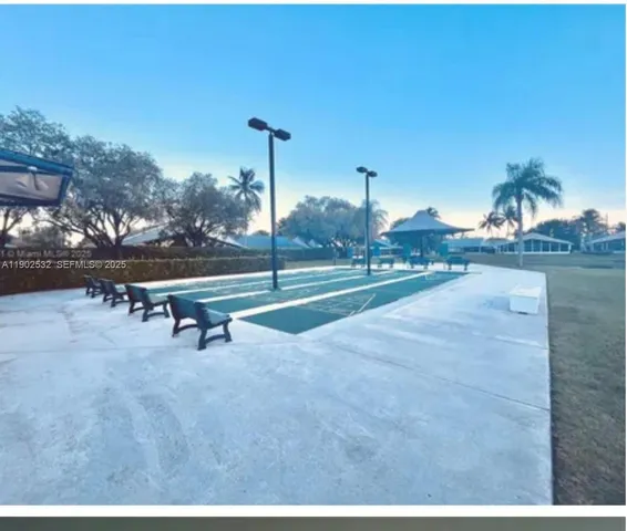 a room with lots of white furniture and a shower