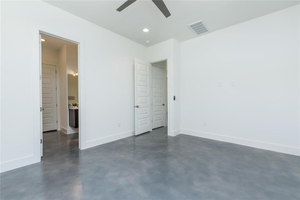 1403 Arcadia Avenue, Unit A Austin, TX 78757 - Photo 13 of 35 an empty room with closet and a chandelier fan
