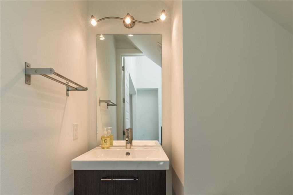 1403 Arcadia Avenue, Unit A Austin, TX 78757 - Photo 25 of 35 a bathroom with a sink and a mirror